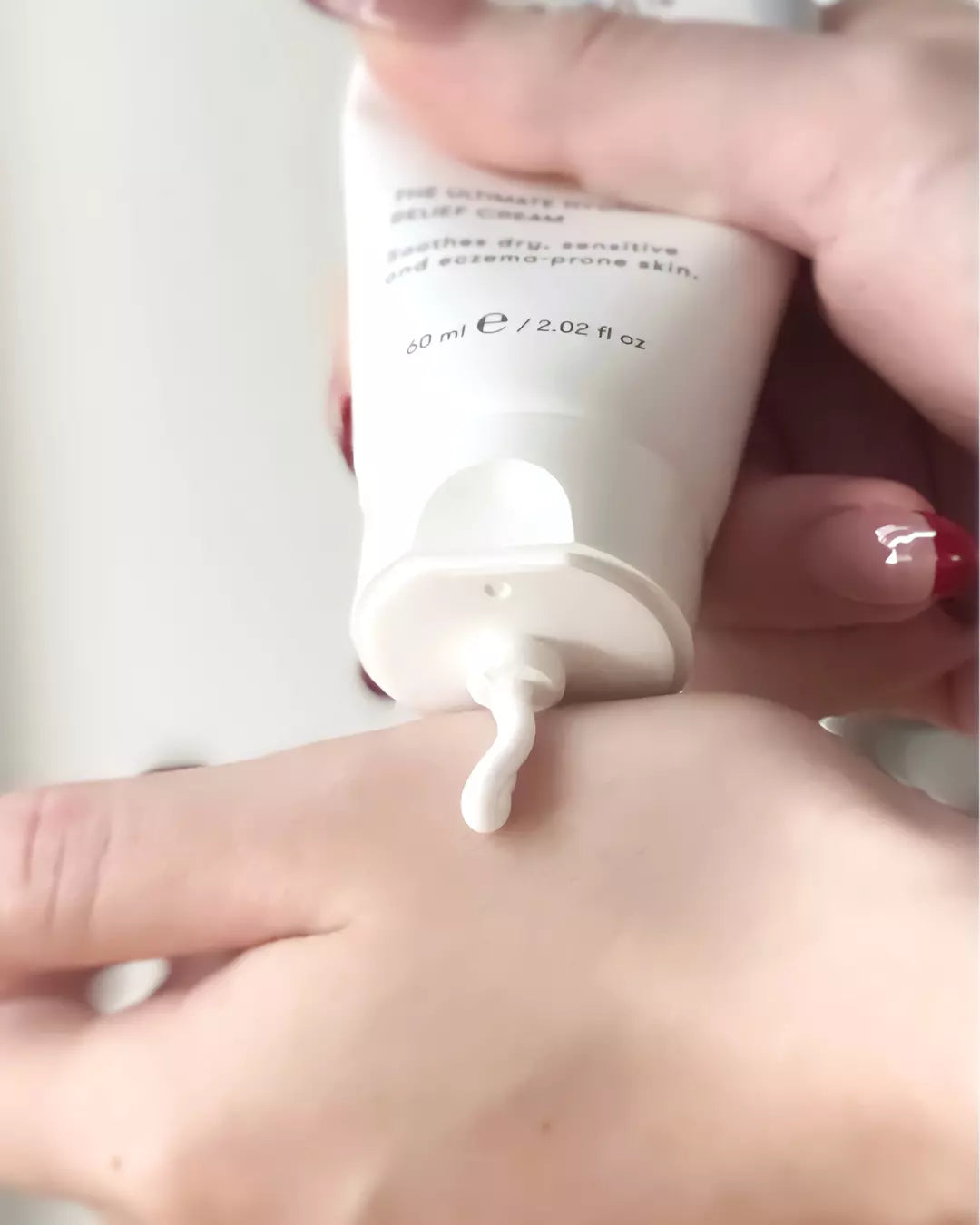 Squeezing Simply Better Barrier Cream on Hand